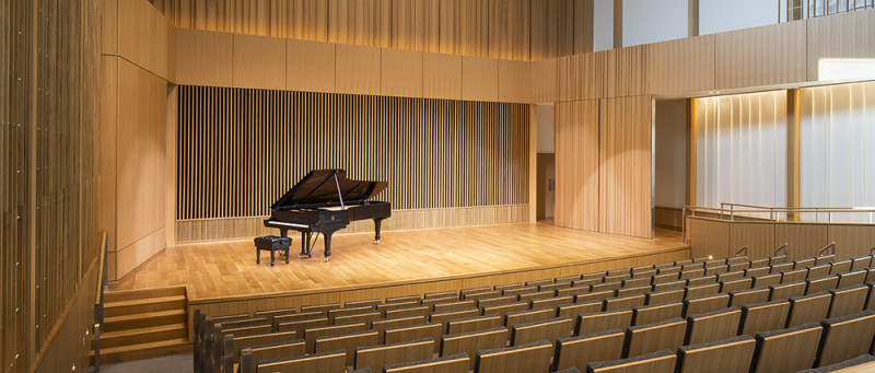 Black grand piano sitting on stage